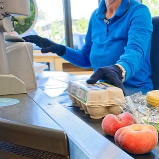 Eine Kassiererin arbeitet in einem SupermarktEinzelhandel.