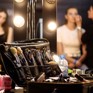 MOSCOW, RUSSIA - JUNE 24, 2022: Models have their make-up applied ahead of a runway show for Victoria Andreyanova by the Kitay-Gorod Wall in Zaryadye Park as part of Moscow Fashion Week scheduled for June 20 to 26. Sergei Bobylev TASS Y TS137959