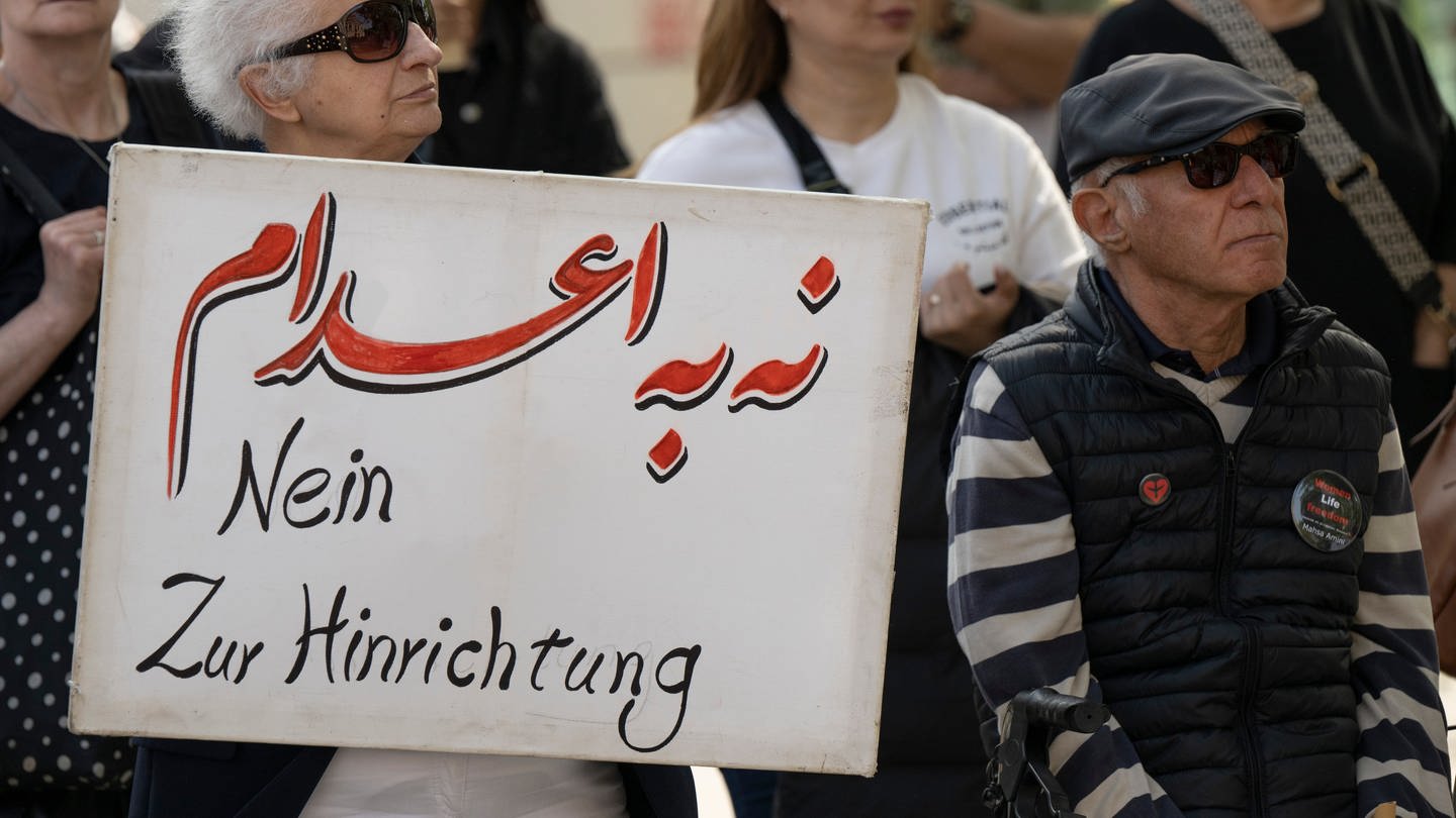 Gegen die jüngsten Hinrichtungen im Iran protestieren Exil-Iraner vor der Alten Oper in Frankfurt. Dabei steht auf einem Plakat „Nein zur Hinrichtung“.