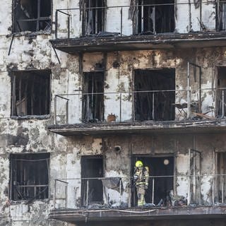 Feuerwehr sichert das ausgebrannte Wohnhaus im spanischen Valencia. Zehn Menschn sind bei dem Brand gestorben.