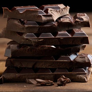Mehrere Tafeln Schokolade liegen aufeinander - Wegen des hohen Kakaopreises musst du bald vielleicht mehr Geld für Schokolade ausgeben. 