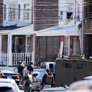 Polizisten umstellen ein Haus. Ein Verdächtiger hatte sich in dem Haus verbarrikadiert und Geiseln genommen, nachdem er in einem Vorort von Philadelphia drei Menschen erschossen hatte.
