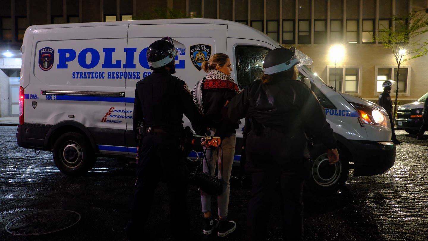 New Yorker Polizeibeamte eskortieren einen Demonstranten vor dem Campus der Columbia University, in New York.