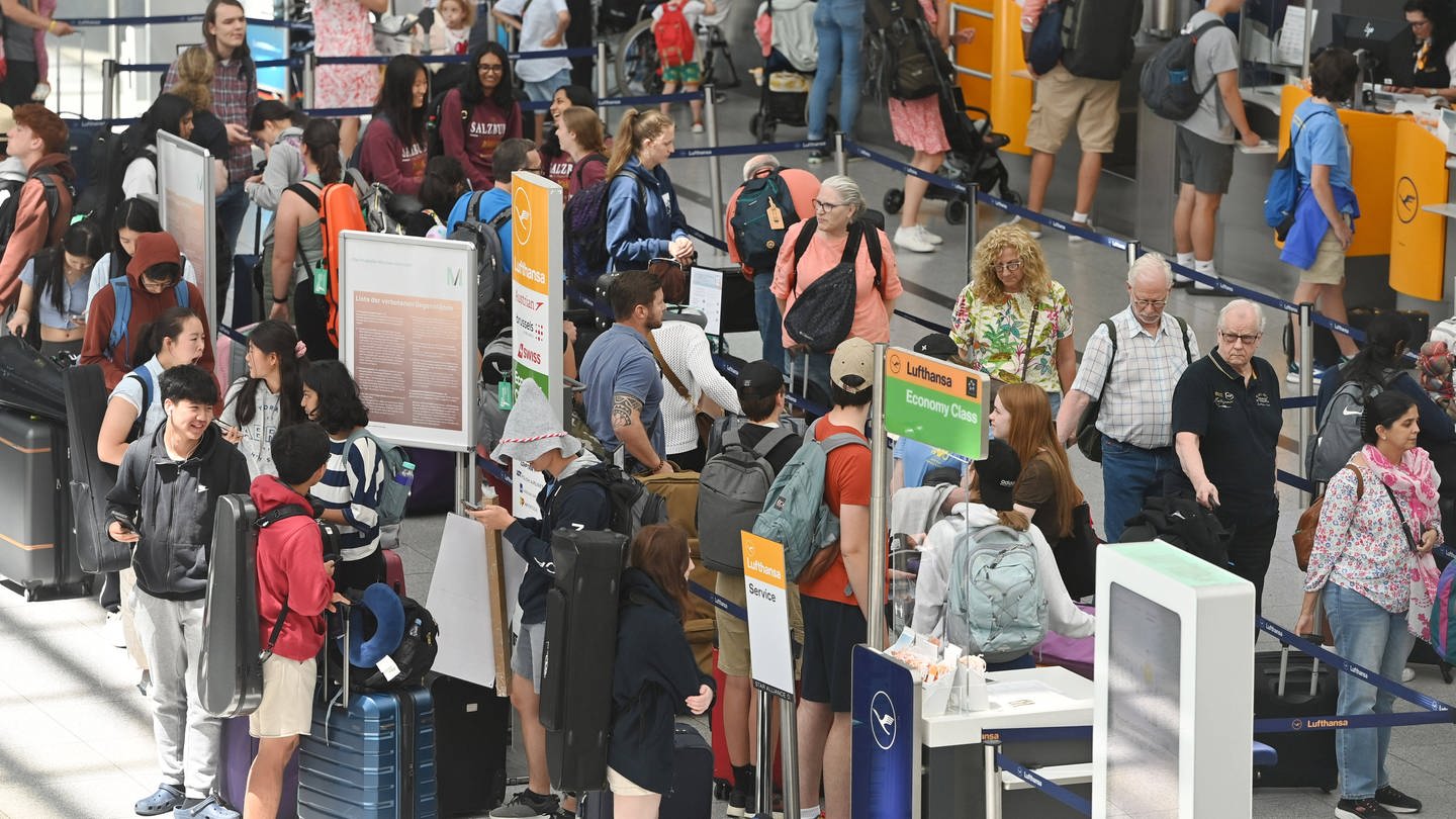 Urlauber vor der Gepackaufgaben am Flughafen: Flüge sind innerhalb der Ferien meist günstiger.