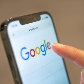 Eine Frau hält ihr Handy in der Hand, auf dem die Google-Seite im Browser zu sehen ist. Vor 25 Jahren wurden die Weichen dafür gestellt, dass «googeln» zu einem Synonym für die Internet-Suche wurde. (zu dpa «Ein Schreibfehler als Pate: Google.com vor 25 Jahren registriert»)