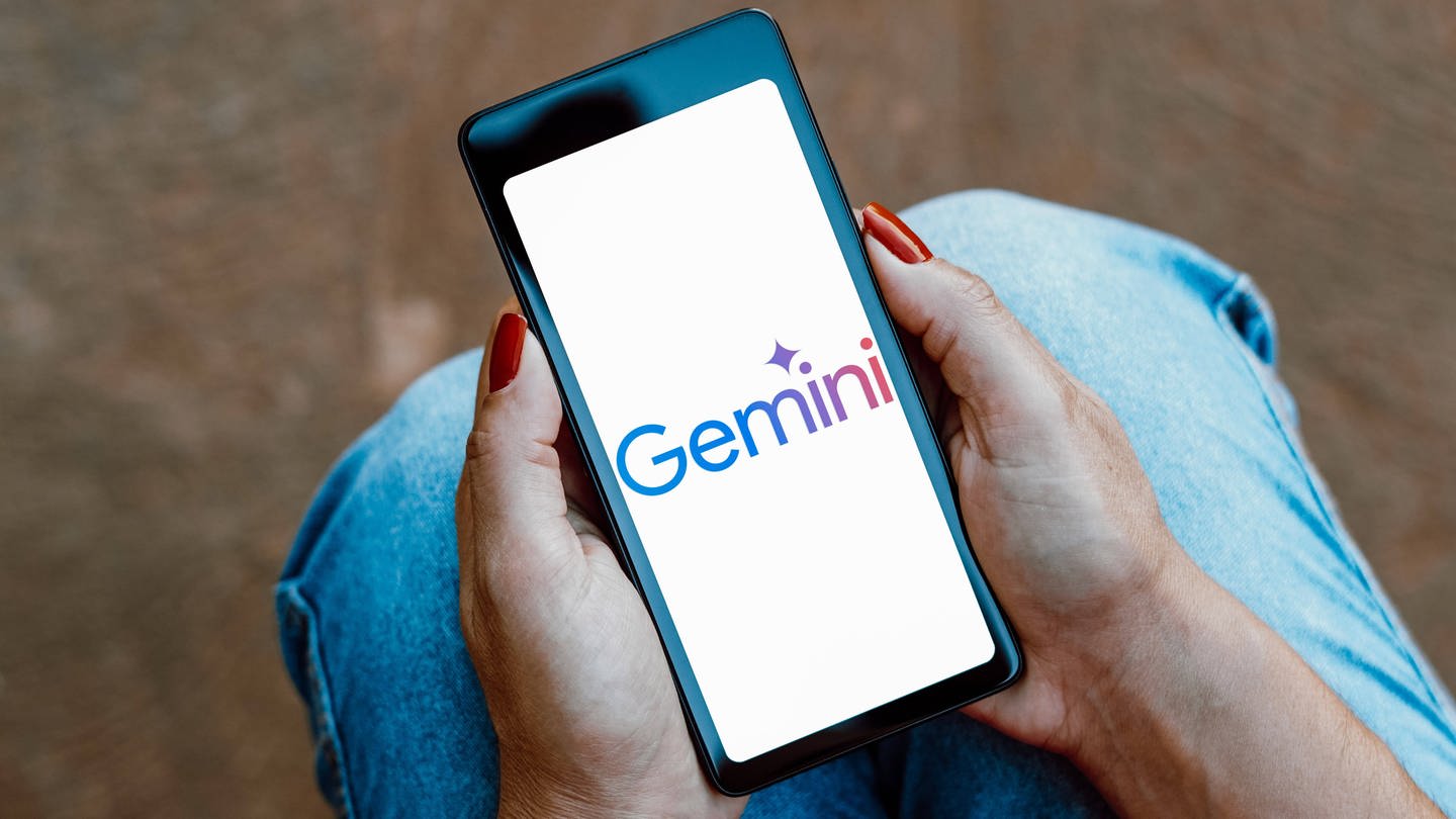 The Google Gemini logo is displayed on a smartphone screen.