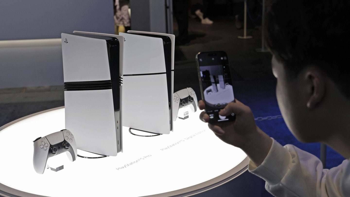 A visitor takes a photo of Sony Interactive Entertainment Inc. s latest PlayStation 5 Pro console at the Tokyo Game Show at Makuhari Messe convention center in Chiba.