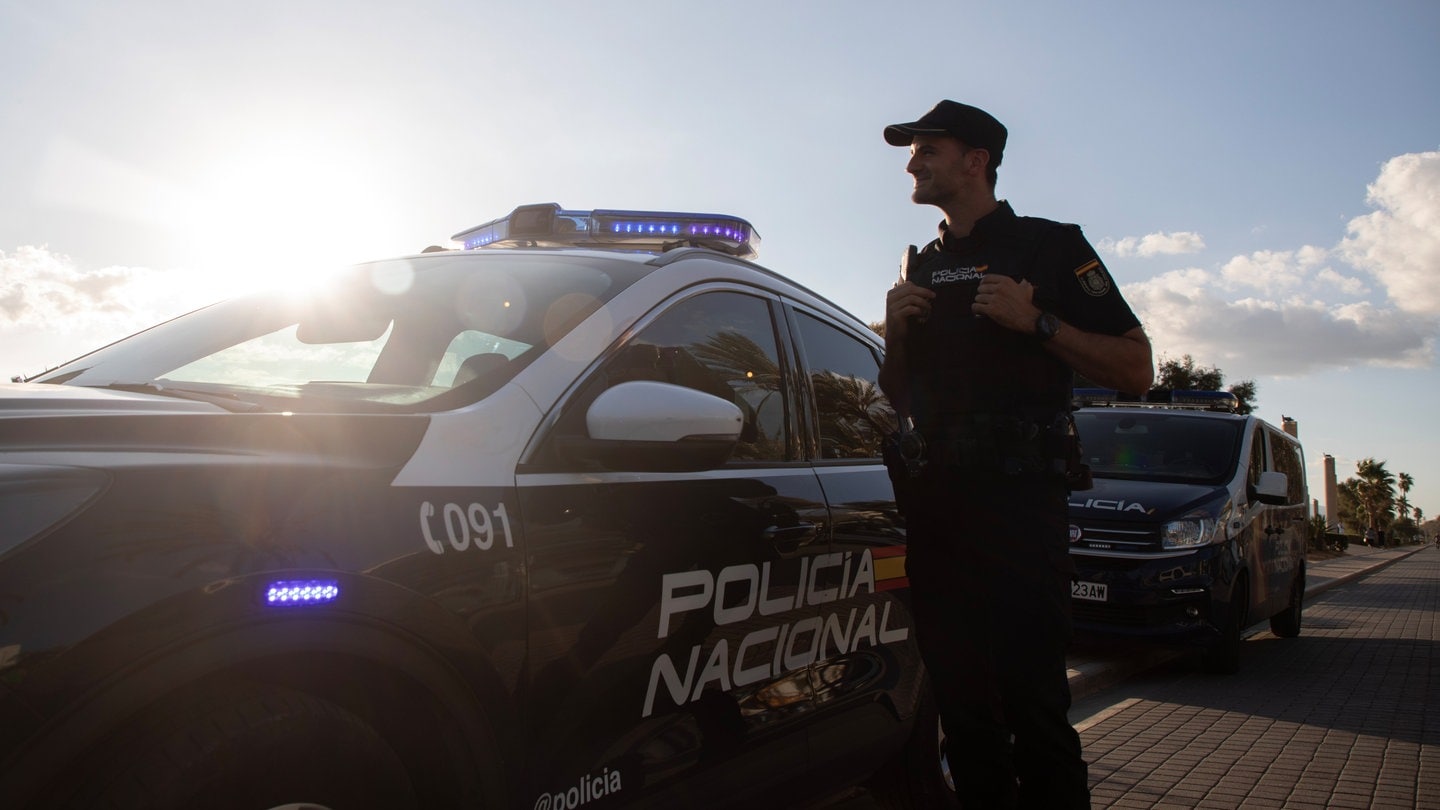 Ein Polizist der spanischen Policia Nacional patroulliert am Strand von El Arenal.