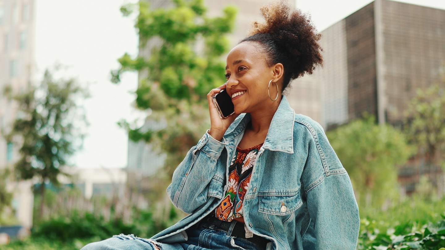 Person telefoniert mit Handy am Ohr. Der Handyausbau in Deutschland wird besser.